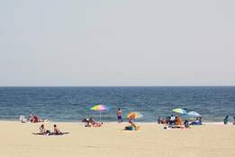 beachgoers enjoying rockaway beach 